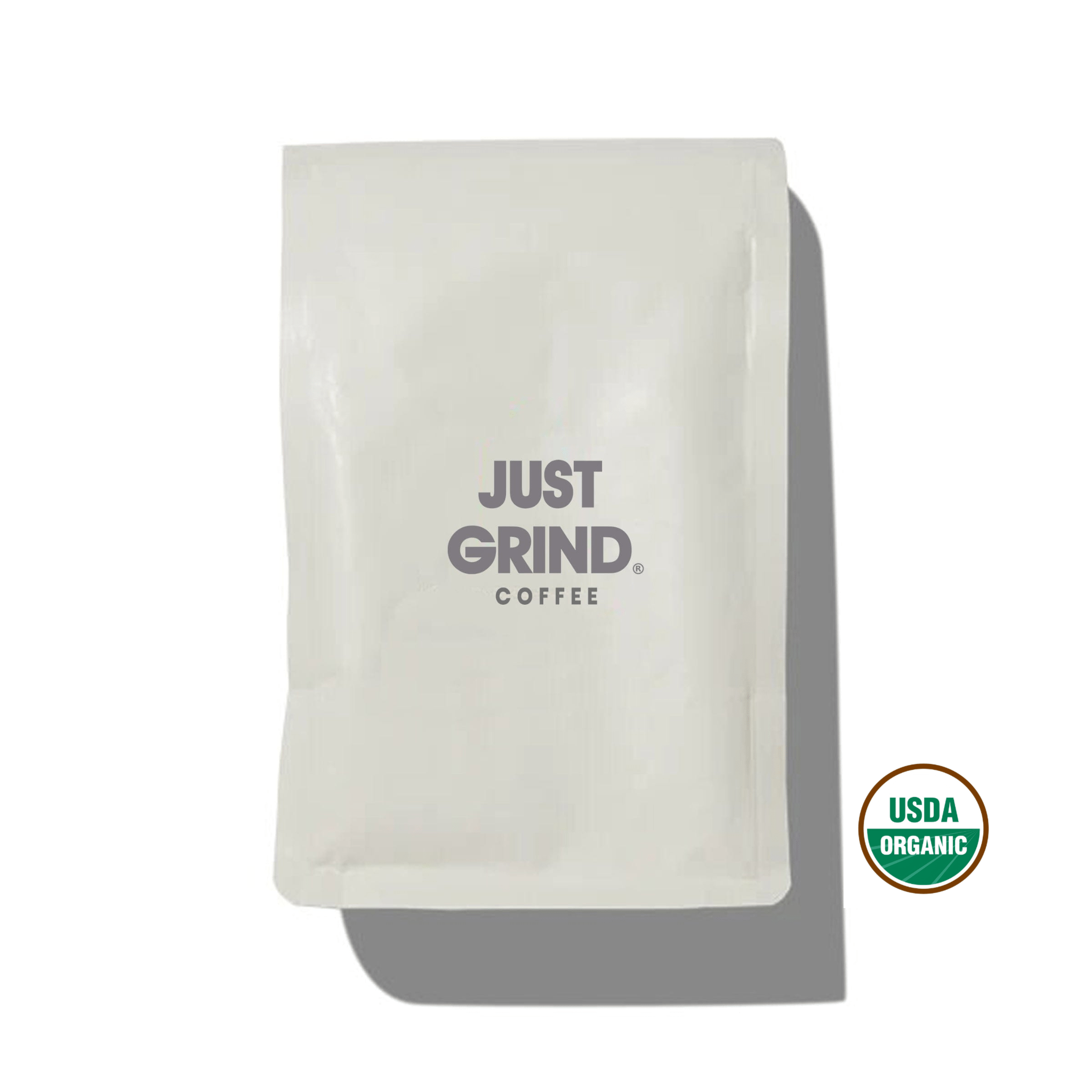 White coffee bag labeled 'Just Grind Coffee' against a white background.